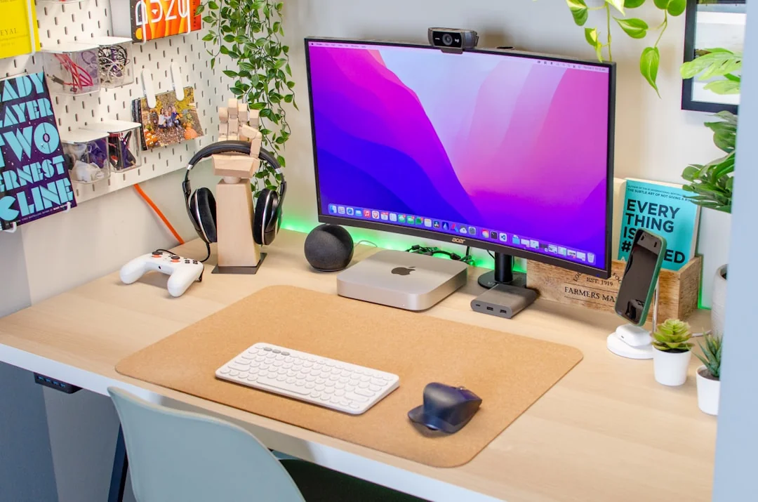 Man working on web design at home office setup with dual monitors.