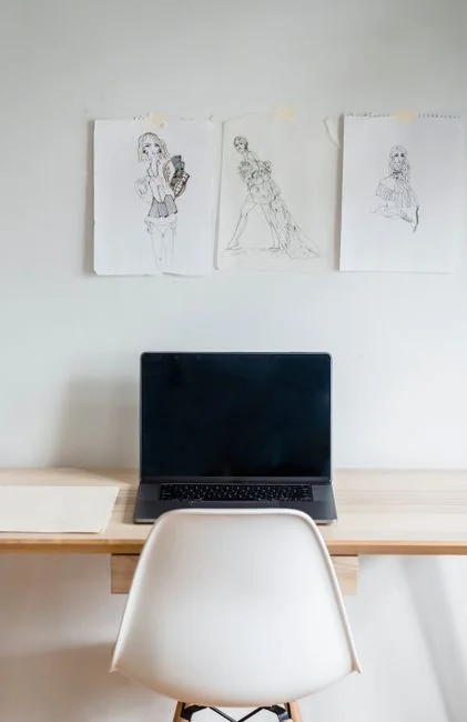 A minimalist desk setup featuring dual monitors, keyboard, mouse, and notebook for productivity.
